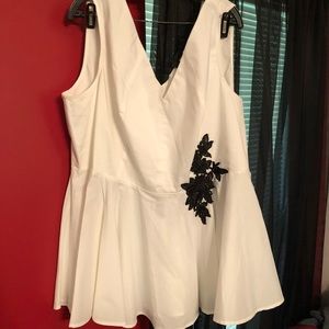 Sleeveless peplum top with black embroidery